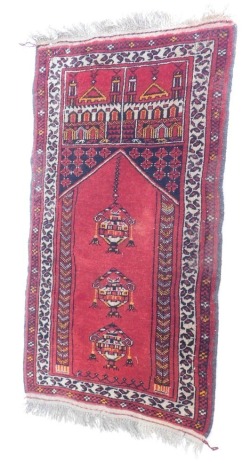 An Eastern prayer rug, decorated with a Mihrab, medallions, geometric motifs, etc., 114cm x 71cm.