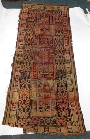 A Persian runner, with a geometric design, in red, orange, black, etc., 287cm x 122cm. (AF)