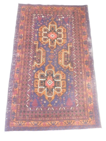 A Persian rug, with two medallions, on a deep blue ground within four narrow borders, 195cm x 118cm.