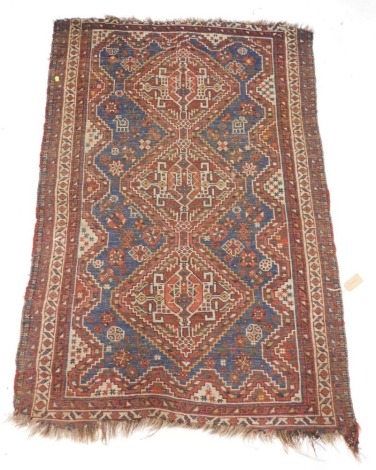 A Shiraz rug, with a central pole medallion in orange, on a blue ground with narrow borders, 153cm x 108cm.