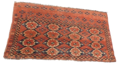 A Turkoman camel bag or juval, with a design of medallions, on a red ground, 136cm x 77cm.