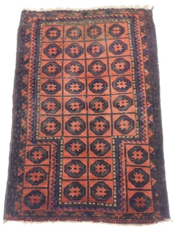 A Turkoman rug, with a design of four rows of star guls within geometric borders, (AF), 133cm x 90cm.