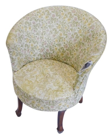 An early 20thC walnut tub shaped chair, later upholstered in gold and pink floral fabric, on square tapering legs.