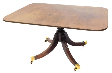 A 19thC mahogany pedestal dining table with moulded oblong top raised on quadruple fluted sabre supports terminating brass caps and castors, 74cm high, 105cm deep.