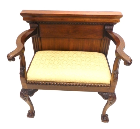 A George III style mahogany window seat, with scroll arms, inverted supports, scroll capped cabriole claw and ball feet, drop in seat in floral material, 82cm high, 83cm wide, 51cm deep.