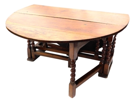 A 17thC and later walnut D end drop leaf table, on heavy turned barley twist legs, joined by block stretchers, when open 75cm high, 175cm wide, 152cm deep.