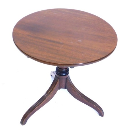 A mahogany occasional table, with a circular top on a turned column and reeded tripod base, 53cm high, 56cm wide.