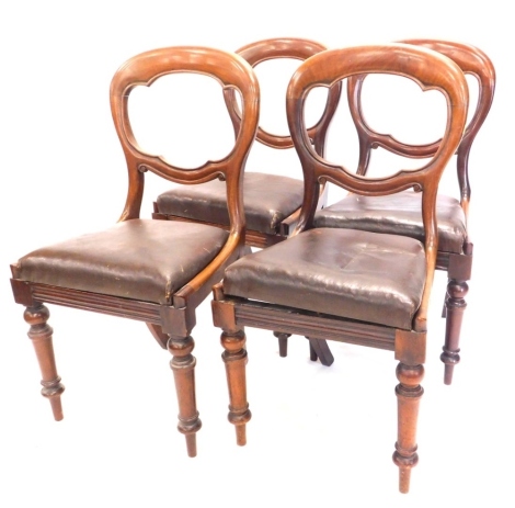 A set of four Victorian mahogany balloon back chairs, each with a drop in seat, on turned legs.