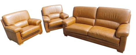 A tan coloured leather three piece suite, with cream stitching, comprising sofa and two armchairs, the sofa 190cm wide.