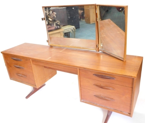 An Austin Suite teak dressing table, with triple mirror and six drawers, on end supports, 170cm wide.