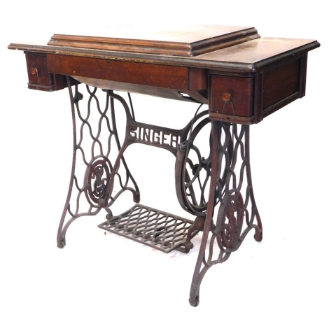 A Singer treadle sewing machine, in walnut and iron case, 92cm wide.