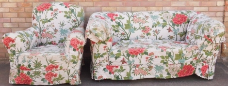 A late 19th/early 20thC drop arm Chesterfield sofa, with loose cushions, on bun feet, 163cm wide, and a matching armchair.