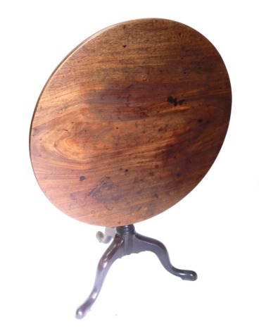 A George III mahogany tilt top table, with a circular top, on a turned column and tripod base with pad feet, 83cm diameter.