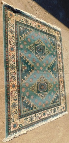 A machine woven Eastern pattern rug, in blue and cream with multiple borders, 200cm x 280cm.