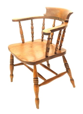 A late 19th/early 20thC beech and elm captain's chair, with spindle turned supports and turned legs with H stretcher.