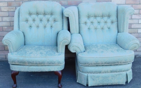 Two similar armchairs, each upholstered in green and pale blue fabric, one with cabriole legs.