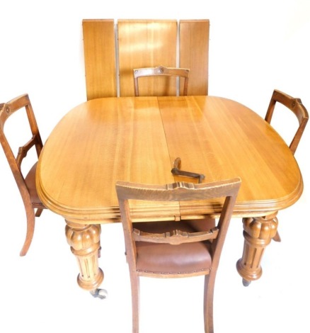 A Victorian oak extending dining table, the top with a moulded edge and rounded corners, on bulbous carved, turned and fluted legs with castors, three loose leaves, 70cm high, 117cm wide, 223cm long and a set of four Victorian ash aesthetic style dining c