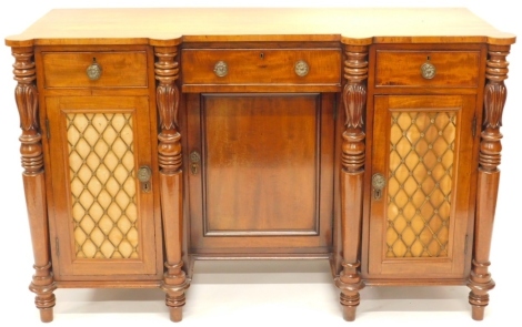 An early Victorian mahogany sideboard, centred by a frieze drawer, with pierced metal mesh work cupboards, flanked by acanthus leaf columns, with a central cupboard on turned feet, 86cm high, 134cm wide, 50cm deep.