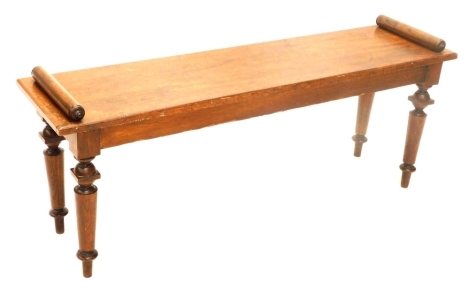 A Victorian oak bench or window seat, with cylindrical arms, on turned tapering legs, 122cm wide.