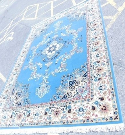 A floral machine woven Turkish style carpet, on a blue ground, 350cm x 253cm.