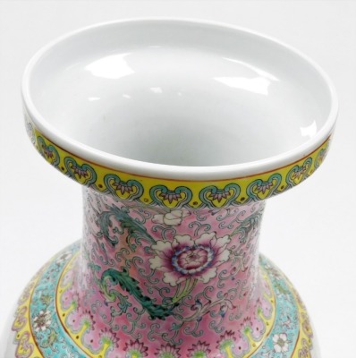 A Chinese porcelain vase, decorated in coloured enamels with buildings, trees, mountains, etc., within pink, turquoise and yellow borders, calligraphy to reverse, square red mark to underside and script, ''Oriental hand painted in China''. - 5