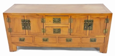 A Chinese elm sideboard, the top with two short drawers flanked by two cupboards, the base with four short drawers, with rectangular brass plates with shaped handles, on bracket feet, 58cm high, 139cm wide, 48cm deep. - 2