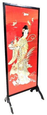 An Oriental silk screen, depicting a figure holding tray with various tea wares, mounted in a black painted frame on shaped supports, 102cm high, 79cm wide.