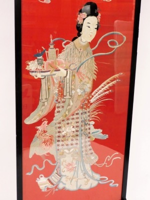 An Oriental silk screen, depicting a figure holding tray with various tea wares, mounted in a black painted frame on shaped supports, 102cm high, 79cm wide. - 2