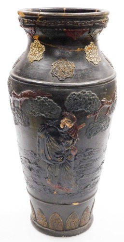 A Japanese Meiji period earthenware vase from the Tokoname kilns, relief decorated with sages and other figures beside trees, 48cm high.