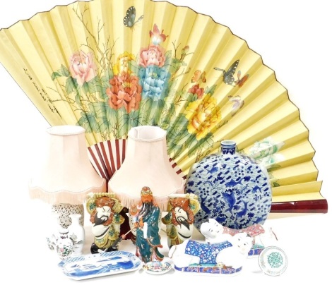 A collection of Chinese porcelain items, to include a moon flask, two figural pillows, figures, table lamps with pierced decoration, transitional style vases, and a large fan. (a quantity)