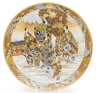 A Japanese earthenware hexagonal shaped plaque, decorated with numerous figures in a village scene, unmarked, 36cm wide, and a Japanese Meiji period earthenware plaque, with similar decoration (AF), 32cm diameter. - 2