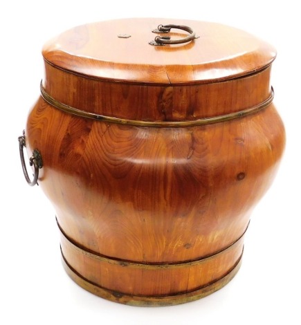 A Chinese brass bound pine rice bucket and cover, with brass banding and handles, 41cm high, 42cm wide.