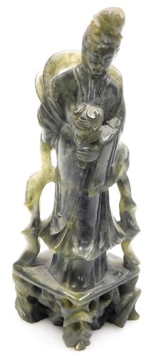 A Japanese green hard stone carving of Guan Yin, the Goddess of Mercy, 21cm high.