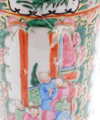 A pair of Cantonese famille rose porcelain vases, with flared rims, decorated with reserves of figures, flowers, birds, etc., 30cm high (AF), and a 19thC pottery figure of a dog of fo, 11cm high. (AF) - 11