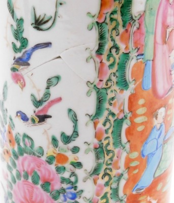 A pair of Cantonese famille rose porcelain vases, with flared rims, decorated with reserves of figures, flowers, birds, etc., 30cm high (AF), and a 19thC pottery figure of a dog of fo, 11cm high. (AF) - 12