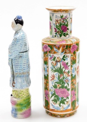 An Oriental porcelain vase, of cylindrical shouldered form, decorated with repeat reserves of figures, flowers, butterflies, etc., 33cm high, and a pottery figure of a deity, 32cm high. (2) - 2