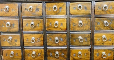 A Chinese elm spice or apothecary cabinet, with an arrangement of twenty drawers, above a pair of cupboard doors and two further drawers, raised on bracket feet, 76.5cm high, 60cm wide, 25cm deep. - 2