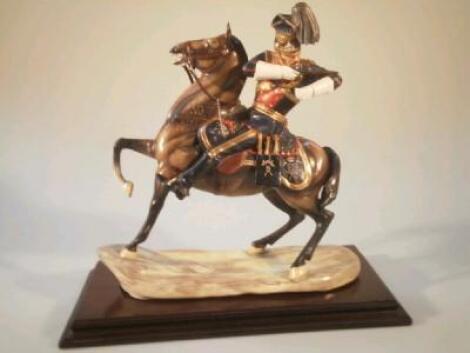 A Michael Sutti porcelain figure of a Lancer firing a revolver on horseback