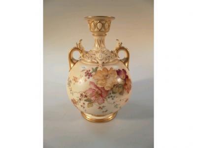 An Edwardian Royal Worcester blush ivory baluster vase decorated with flowers