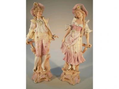 A pair of late 19thC/ early 20thC bisque coloured figures