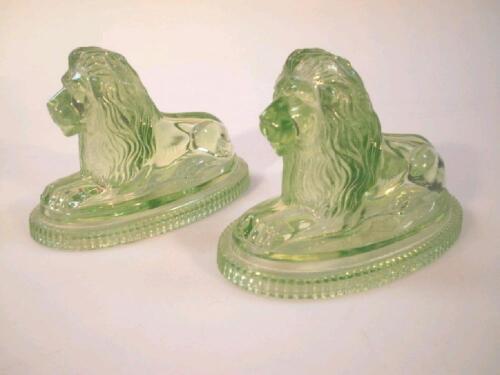 A pair of green glass Victorian moulded recumbent Landseer lions by John Derbyshire