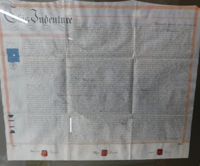 An indenture, dated 1875, for Sarah Ann Townsend and Elizabeth French, glazed and framed, 72cm x 85cm and a further Indenture. (2) - 4