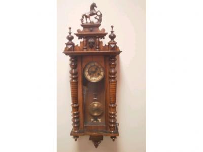 A late Victorian walnut and mahogany cased wall clock