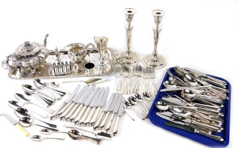 Various silver plated ware, an oblong tray with shaped handles set with leaf and berry outline and etched centre, 60cm wide, a William IV style silver plated part service, comprising teapot and milk jug, pair of candlesticks, large quantity of flatware, p