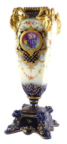 A 20thC Continental vase, with rams head corners, the main body decorated with panels of flowers with gilt highlights, 31cm high.