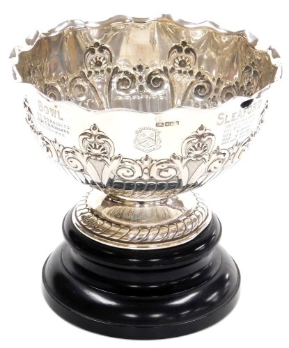 An Edward VII silver presentation bowl, The Sleaford Croquet Club Lincolnshire Championship Challenge bowl, of semi fluted form, embossed with foliate scrolls and shell motifs, engraved with an armorial and the winners from 1907-1932, Atkin Brothers, Shef