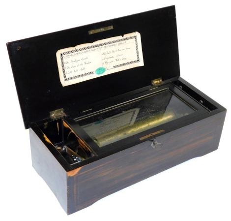 A late 19thC Swiss musical box, playing six airs, in an ebonised case, 42cm wide.