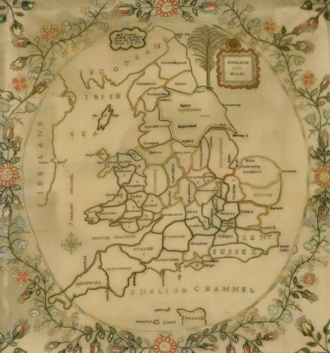 A George III silk work map of England and Wales, by Elizabeth Condon, aged 10 years, done at Sileby School, AD 1813, showing a map of England and Wales divided into its counties, in a surround of flowers, 53.5cm x 51cm.