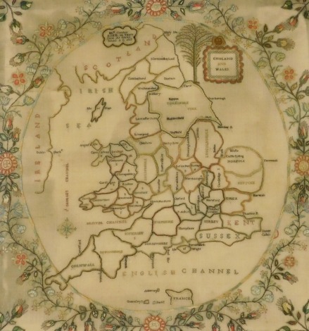 A George III silk work map of England and Wales, by Elizabeth Condon, aged 10 years, done at Sileby School, AD 1813, showing a map of England and Wales divided into its counties, in a surround of flowers, 53.5cm x 51cm.