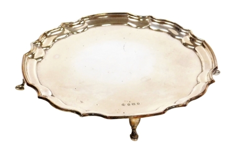 An Elizabeth II silver salver, with a pie crust border, raised on four hoof feet, Francis Howard Ltd Sheffield 1973, 5.56oz, 20cm diameter.